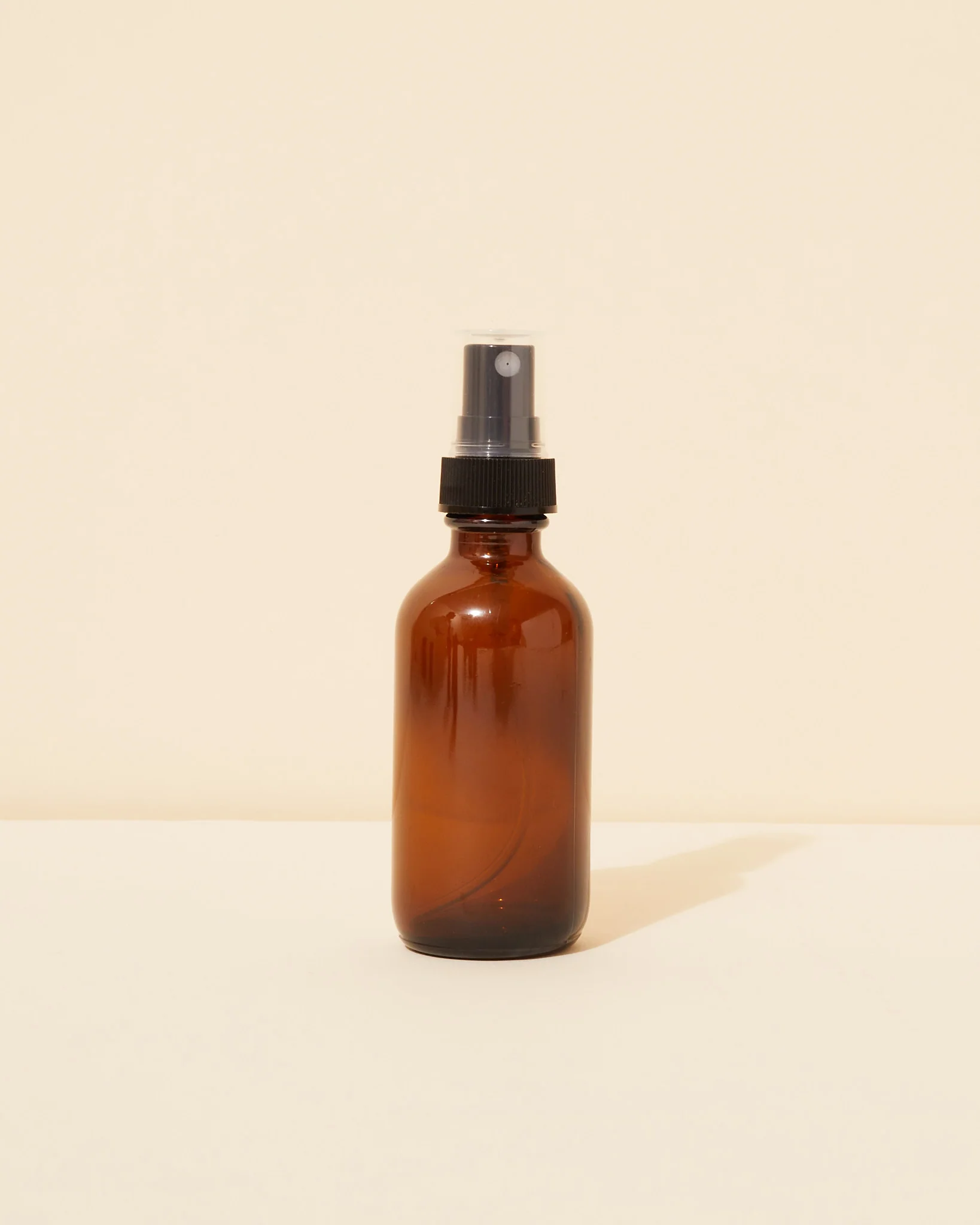 2oz / 59ml translucent amber glass spray bottle